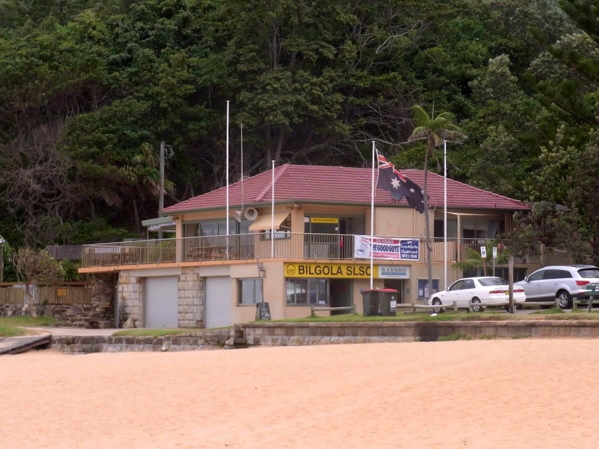 The Bilgola Surf Life Saving Club building above the sand, bush behind it