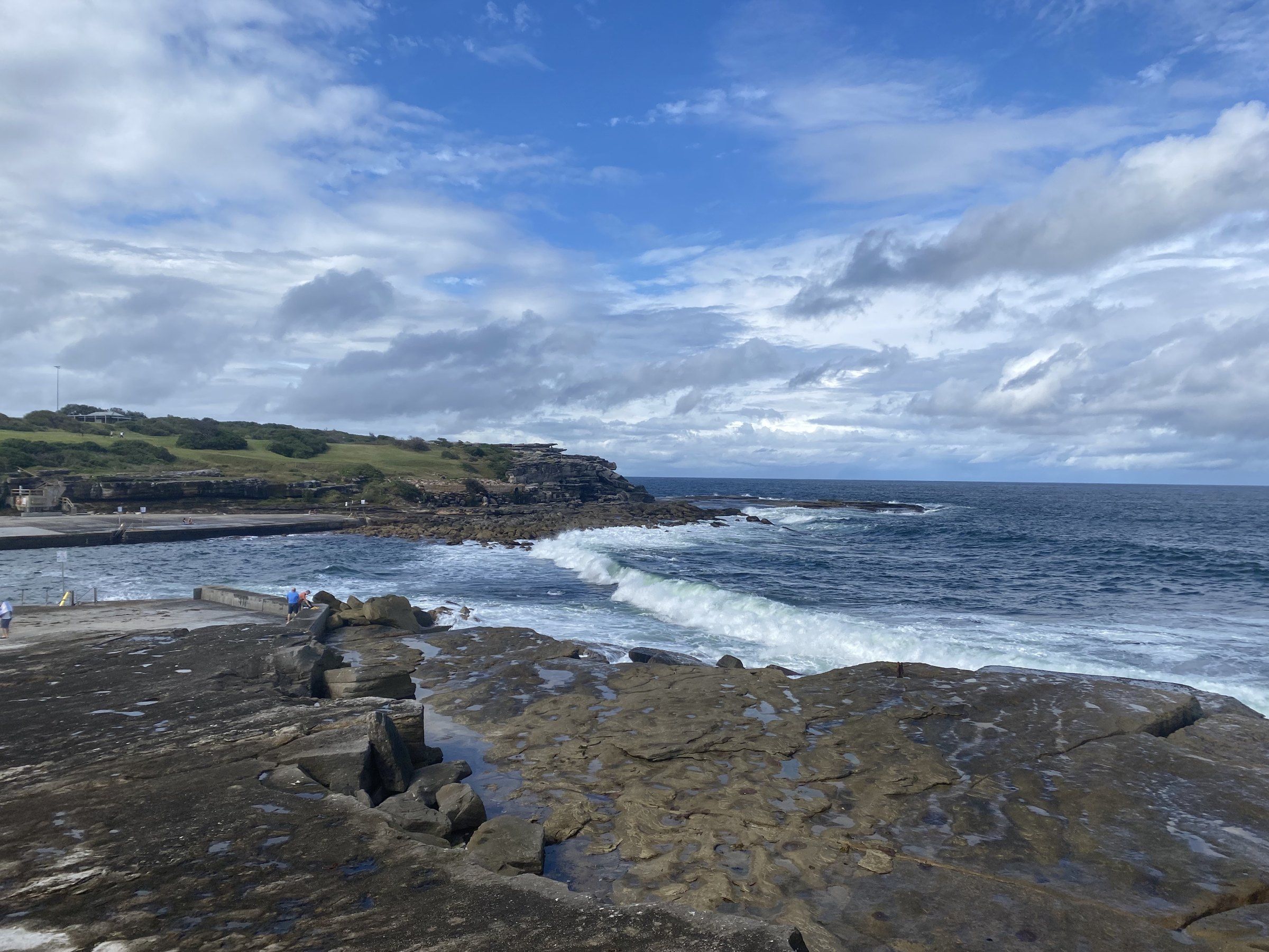 The rock platform and clear water at the mouth of the bay at Clovelly
