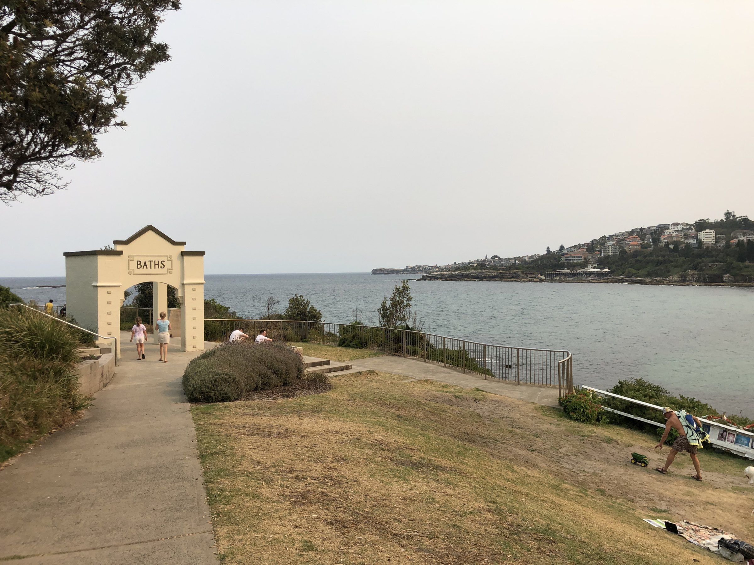 The Giles Baths gateway on the headland at the north end of Coogee, the bay behind