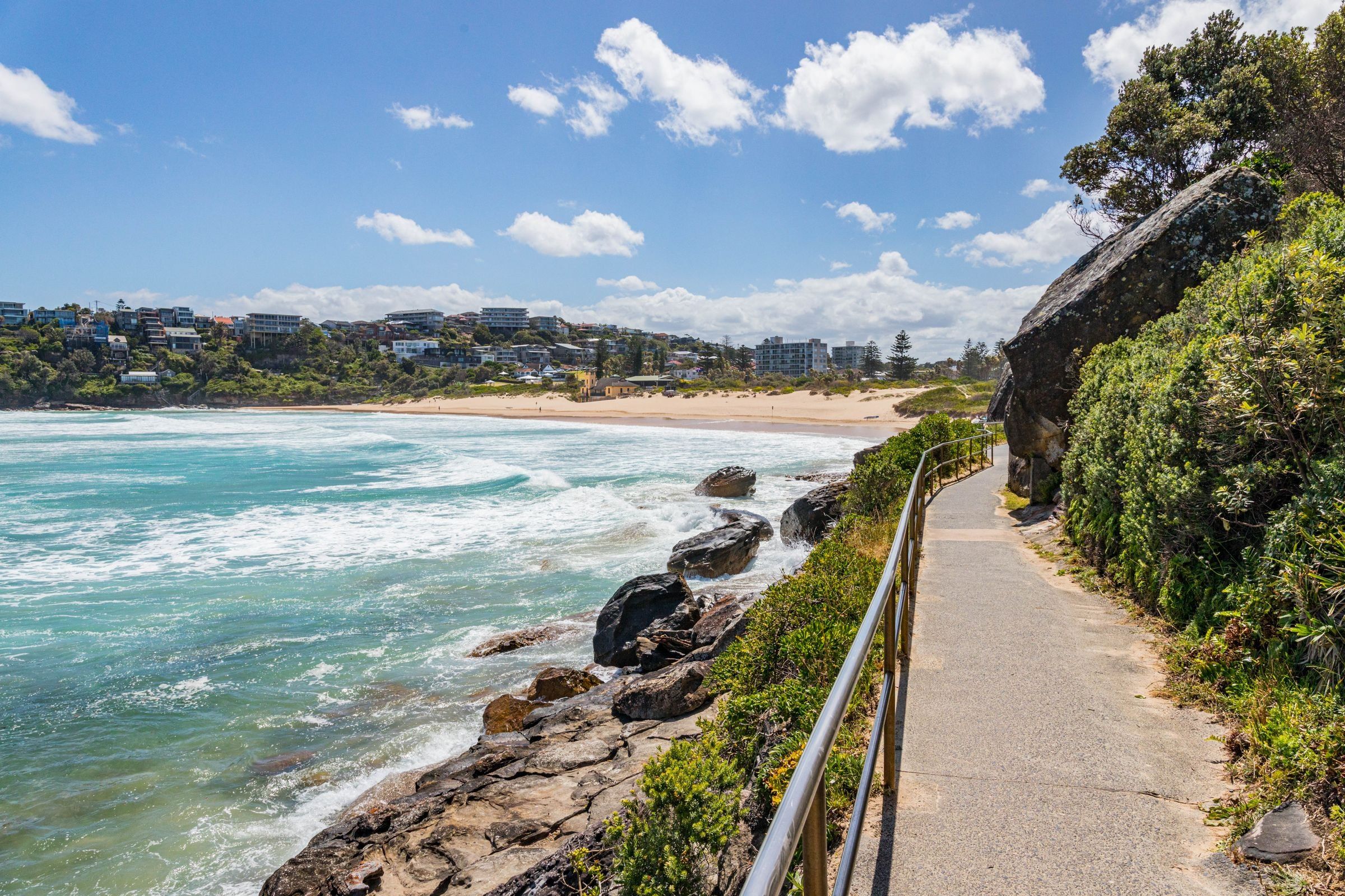 The coastal path above the rocks at Freshwater, the beach and houses beyond