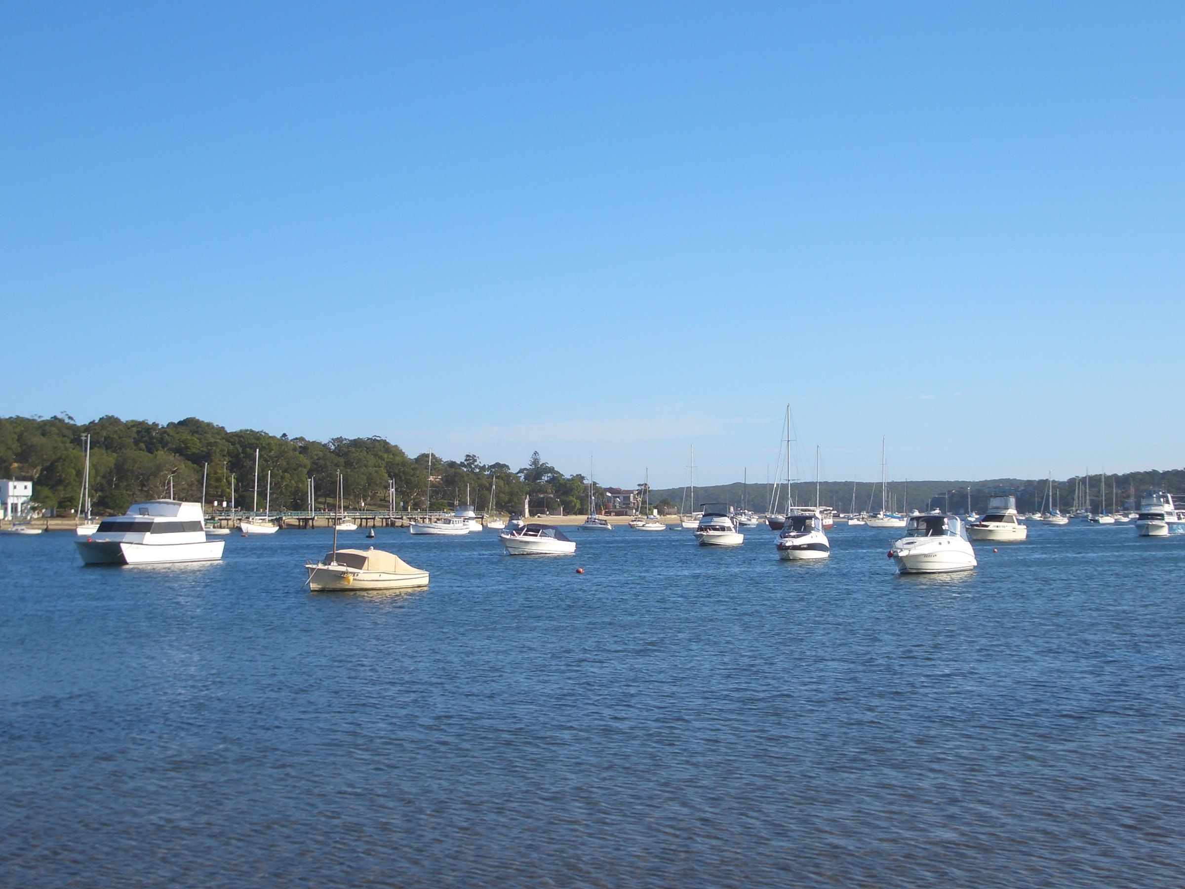 Yachts and motor boats moored on calm blue water in Gunnamatta Bay