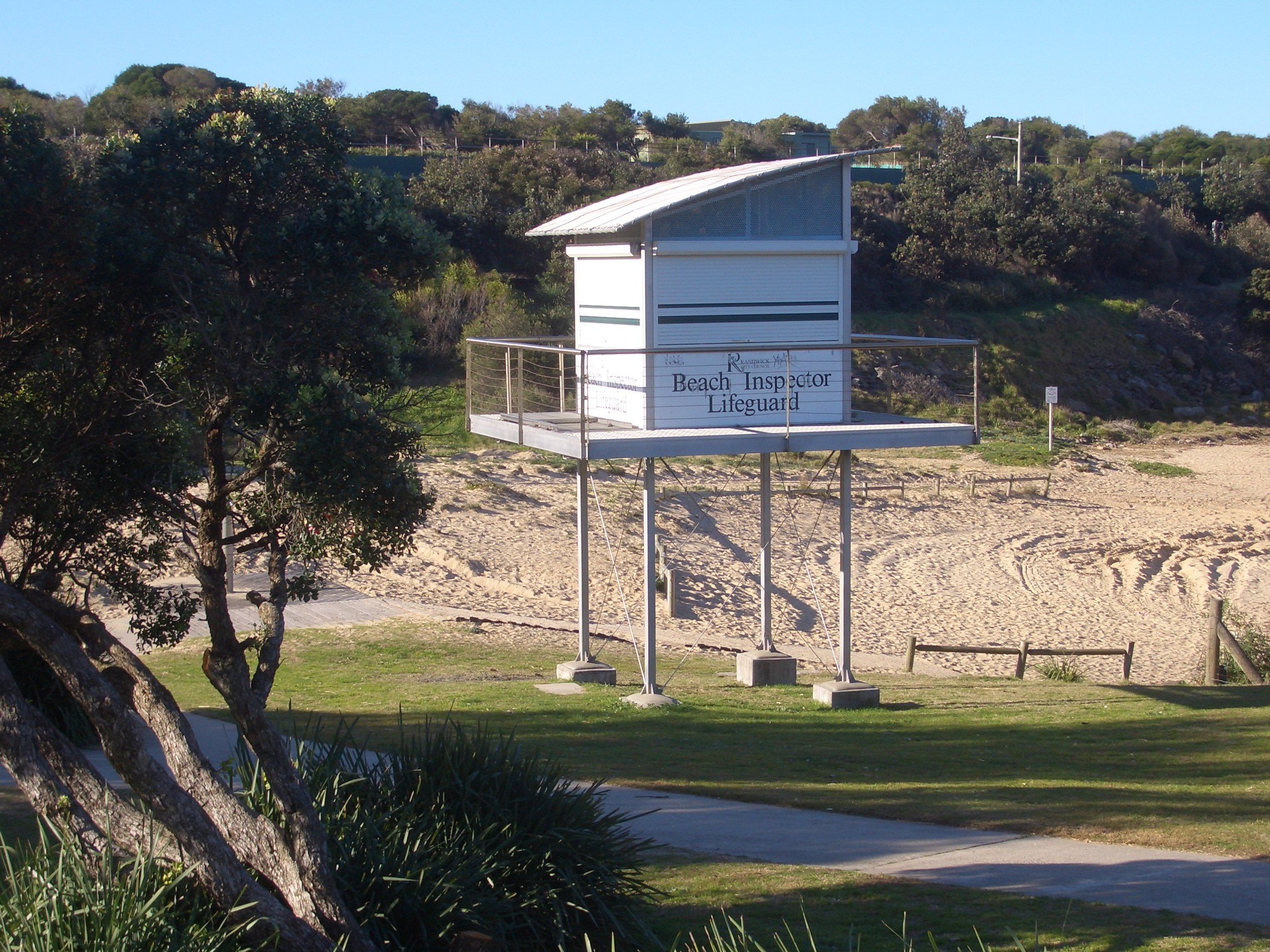 The lifeguard tower on the grass behind the sand at Malabar Beach
