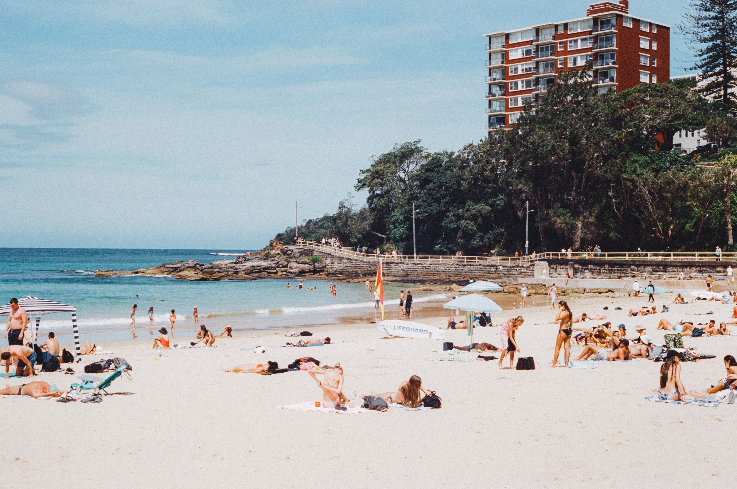Swimmers and sunbathers on Manly Beach in summer