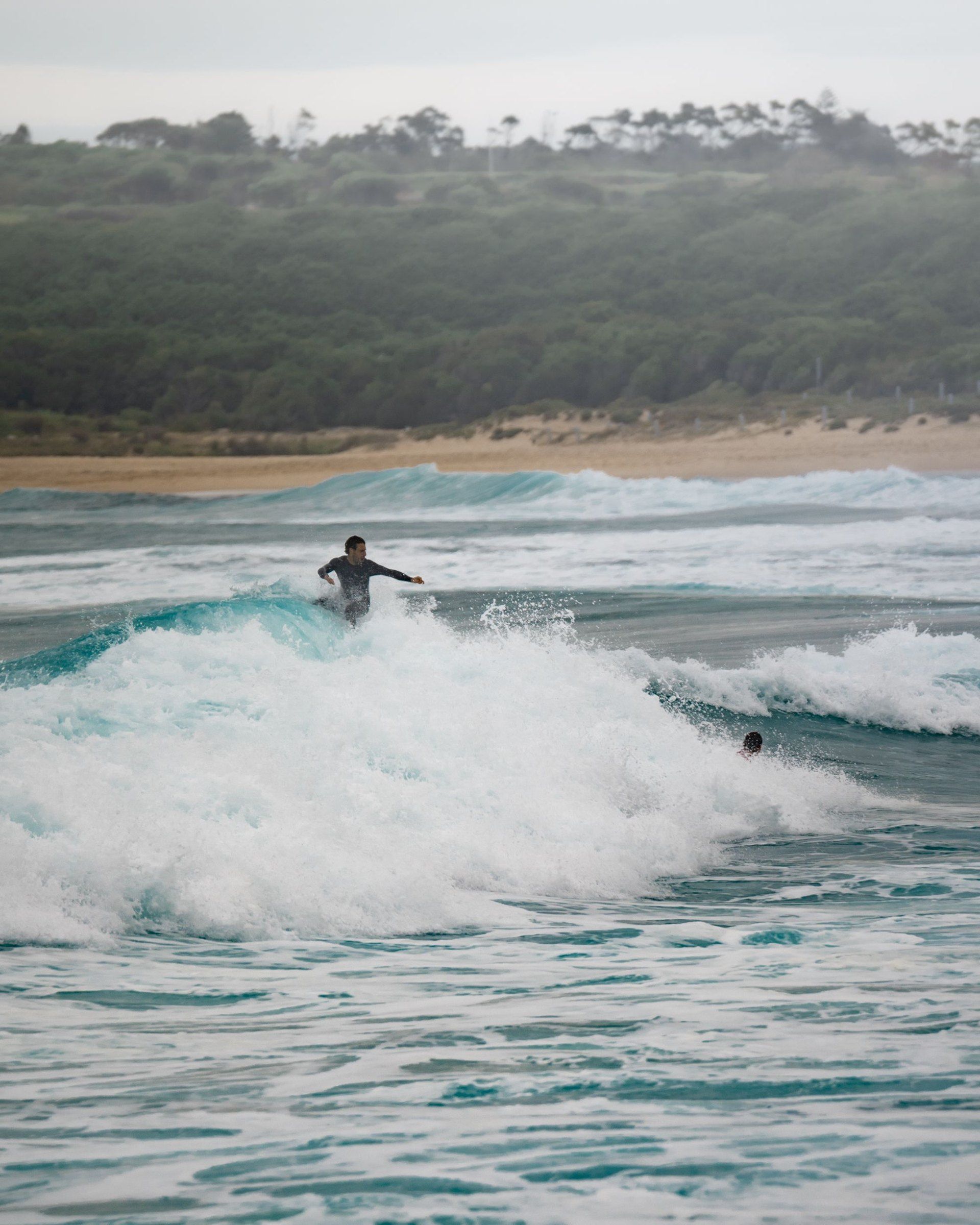 A surfer riding a wave at Maroubra Beach