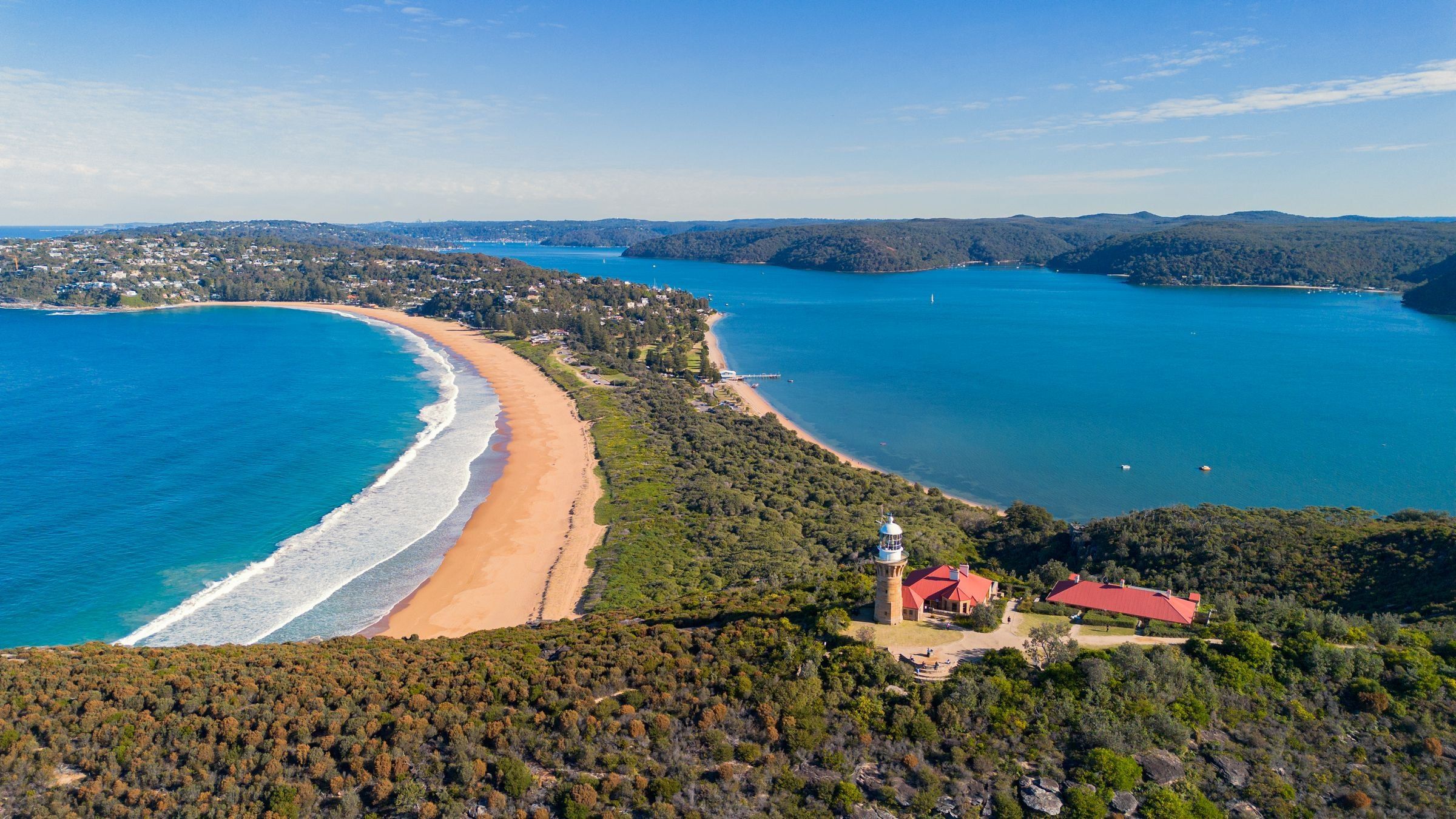 Barrenjoey Lighthouse on the headland, with the ocean beach and Pittwater either side of Palm Beach