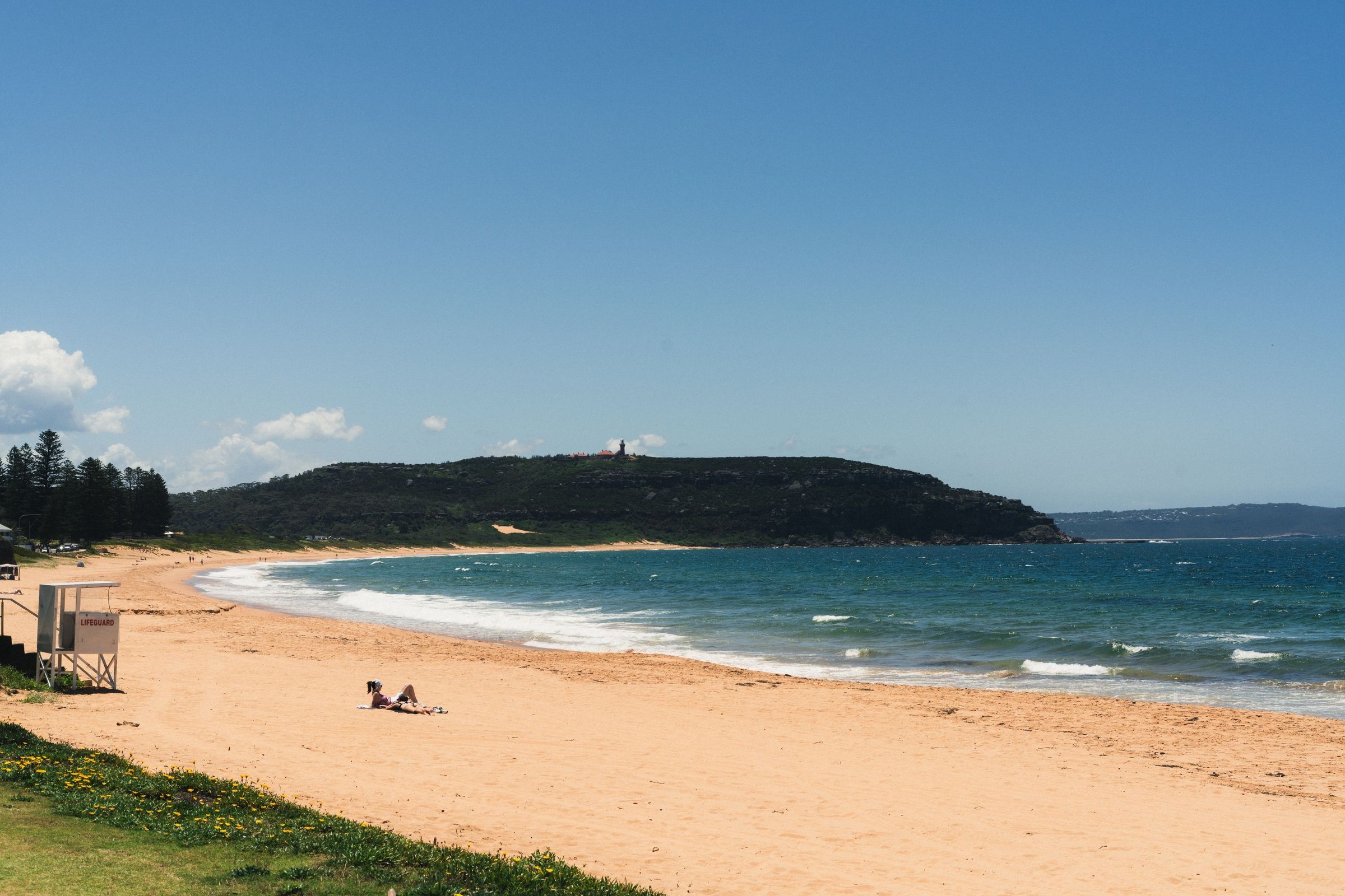 Palm Beach on a clear day, looking north along the sand to Barrenjoey Headland